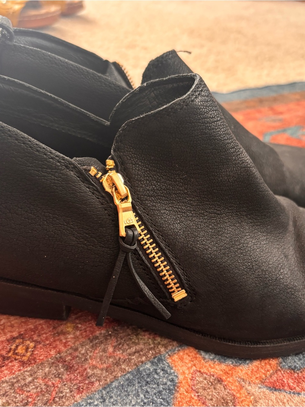 UGG Black Leather Ankle Boot with Gold Zipper Accent